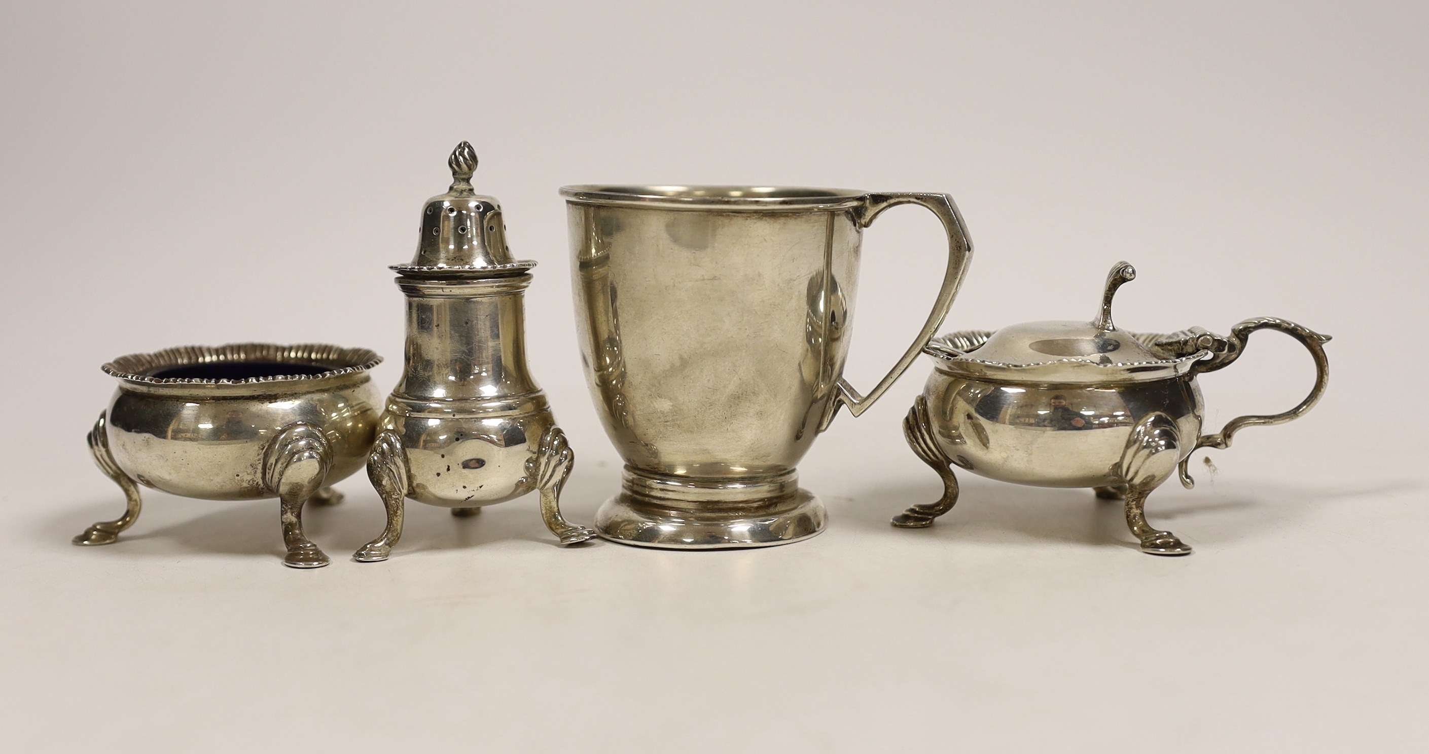 A 1950's silver christening mug, 70mm and a similar silver three piece condiment set.